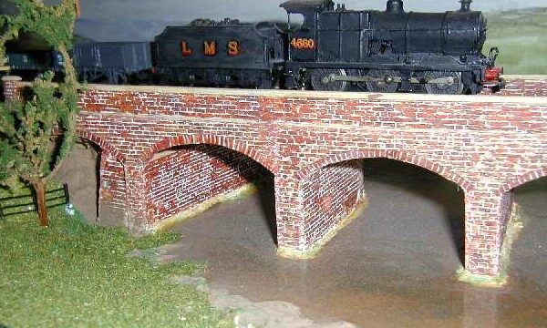 The 4F begins to cross the viaduct which carries the main line tracks over Alston creek.